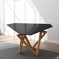 Modern Coffee Table With Black Top And Wooden Cross Legs On Gray Living Room Rug