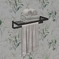 Modern Black Towel Rack With Rolled And Folded Towels On Green Leaf Pattern Wallpaper
