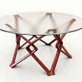 Modern Coffee Table With Round Glass Top And Red Wooden Crossed Legs Design