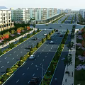Urban Road Infrastructure With Traffic Lanes Green Belts Street Lamps And Sidewalks