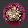 Round Cake Topped With Sliced Pears On Pink Patterned Cloth