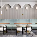 Modern Restaurant Interior With Hanging Lights Booths Tables Chairs Green Plants And Windows