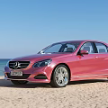 Various Cars Parked On Sandy Beach With Ocean And Blue Sky View