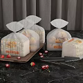Fresh Bread in Transparent Bags on Black Marble Countertop with Strawberries and Tongs