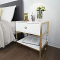 Modern White Bedside Table With Gold Frame One Drawer And Open Book On Lower Shelf