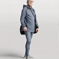 Man Wearing Gray Hoodie and Gray Leggings Carrying Black Bag Standing on White Background