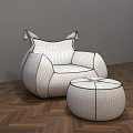 Green Armchair With White Cushion Orange Armrests And Matching Ottoman On Herringbone Wooden Floor