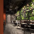 Modern Industrial Restaurant Interior With Green Plant Wall Hanging Lights And Dining Tables