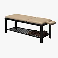 Massage Bed with Black Frame Gray Beige Blanket Pillows and Lower Shelf Stacked Towels