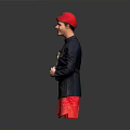 Man In Red Hat Dark Blue Jacket And Red Patterned Shorts Posing With Crossed Hands