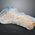 Natural Stone Wood Specimen With Blue Orange Hues And Reflective Surface Texture