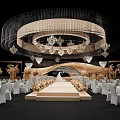 Elegant Banquet Hall With Large Crystal Chandelier Central Runway White Chairs And Golden Floral Decorations