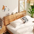Double Bed With Wooden Headboard White Sheets Brown Throw Blanket And Green Plant
