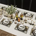 Elegant Golden Dinnerware Set With Black Placemats Candle Holders And Fruit Jars