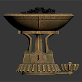 Golden Decorative Bowl With Intricate Base Holding Black Granules And Small Gear