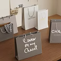 Luxury Shopping Bags With Valentino Chanel Branded Designs On Wooden Table