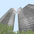 Tall Modern Office Buildings With Glass Curtain Walls Connecting Bridge Green Trees And Blue Sky