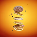 Delicious Assorted Floating Cookies On Bright Orange Background With Crunchy Particles