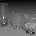 Three Transparent Glass Cups With Different Textured Designs And Stable Bases