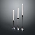 Modern Three Candle Holders With White Candles And Black Metal Conical Bases