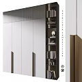 Modern Storage Cabinet With White Panels Gold Handles And Adjacent Bookshelf With Books Decorative Items