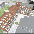 Modern Residential Building With Red Brick Exterior And Balconies In Paved Courtyard