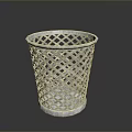 Silver Metal Trash Can With Diamond Lattice Design On Black Surface And Reflection