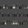 Various Colored and Shaped Wine Bottles and Glasses Arranged Neatly in Rows