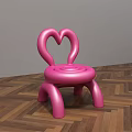 Pink Kids Chair With Heart Shaped Backrest And Rounded Design On Wooden Floor
