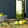 Elegant White Ceramic Plate With Green Fruits Branches And Glass Vases On Dark Blue Table