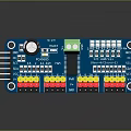 Blue Electronic Circuit Board With Black Capacitor Green Connector And Colored Pins