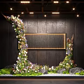 Floral Adorned Curved Garden Art Installation With Greenery Stones And Dark Wall Background
