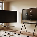 Two Black Televisions With Smart Interface On Stands In Room With Window And Wooden Floor
