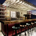 Stylish Bar Counter With Black High Stools Red Cushions White Wooden Decor And Wine Racks