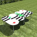 Outdoor Sports Equipment With Black And White Striped Connected Table Sections On Green Lawn