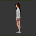 Smiling Woman With Long Hair In Gray Dress And Light Gray Cardigan Against Gray Background