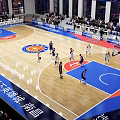 Modern Basketball Gymnasium with Live Game Players Spectators Bright Lighting and Court Seating