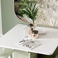 White Dining Table Set With White Chairs Green Plant And Magazine On Light Wooden Floor