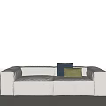 White Two Seater Sofa With Navy Blue And Green Cushions In Minimalist Design