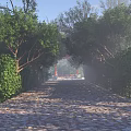 Red Scenic Wall Along Stone Paved Path With Lush Greenery White Statues And Misty Background