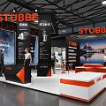 STUBBE Exhibition Booth Design With Orange And Black Display Area Reception Desk And People