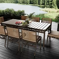 Outdoor Deck Table With Chairs Fruits Wine Glasses By Lake And Trees
