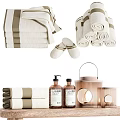 Cozy Bathroom Accessories Set With Soft Rolled And Stacked Towels Wooden Table Candles And Bottles