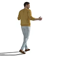Man In Yellow Sweater Light Blue Jeans Pointing With Smile And Gesturing