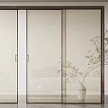 Elegant Modern Sliding Doors With Textured Glass Panels Metal Frame And Indoor Plant
