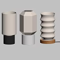 Three Different Shaped Table Lamps With White Shades And Colored Bases On Light Wall