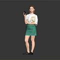 Red Haired Woman In White T-Shirt With Colorful Graphic Green Skirt And Black Shoes Holding Smartphone