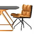 Modern Table and Chair Set With Orange Cushions And Black Geometric Frame Design