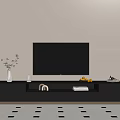 Black TV Stand with Flat Screen TV Decorative Vase Books and Lemon Bowl
