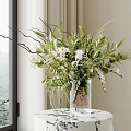 Transparent Glass Vase With White Blooms Green Foliage And Slender Branches On Round Table